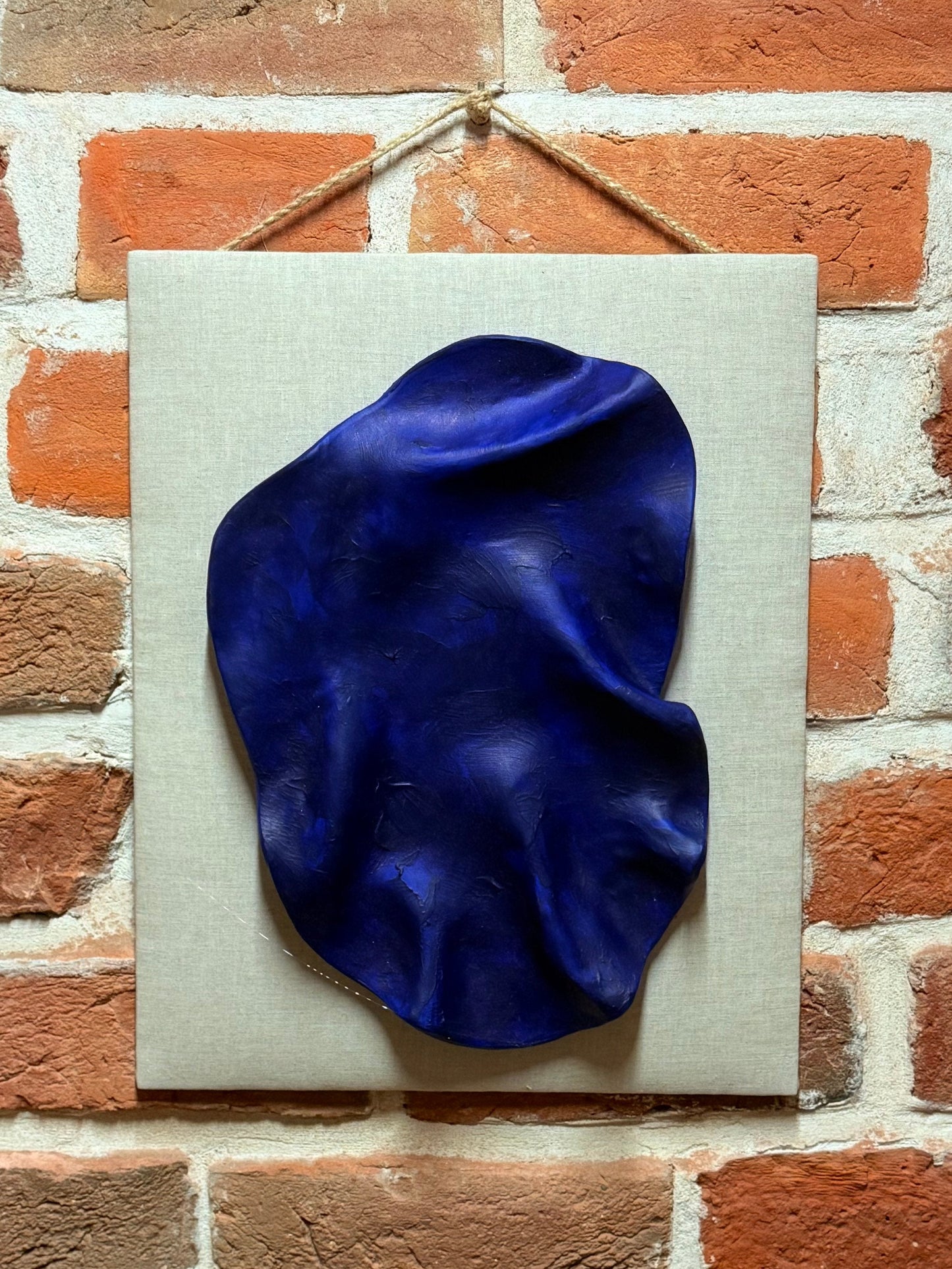 Patera ścienna niebieska pofałdowana na tkaninie